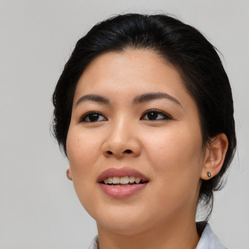 Joyful asian young-adult female with medium  black hair and brown eyes
