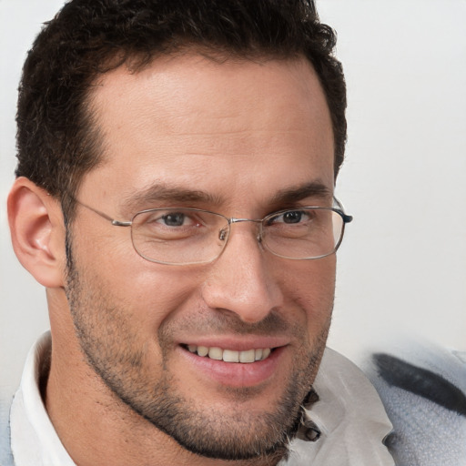 Joyful white adult male with short  brown hair and brown eyes