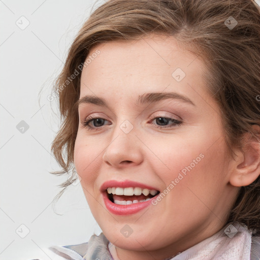 Joyful white young-adult female with medium  brown hair and blue eyes