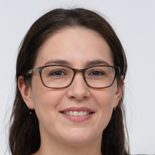 Joyful white adult female with long  brown hair and grey eyes