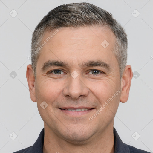 Joyful white adult male with short  brown hair and brown eyes