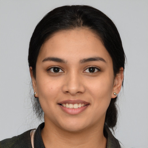 Joyful latino young-adult female with medium  black hair and brown eyes