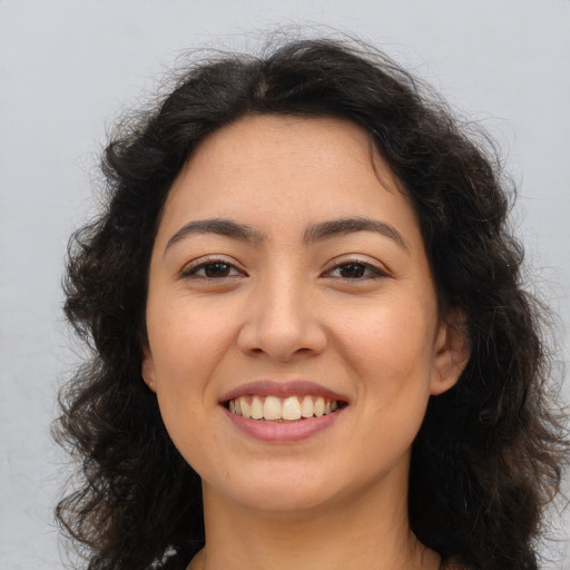 Joyful asian young-adult female with long  brown hair and brown eyes