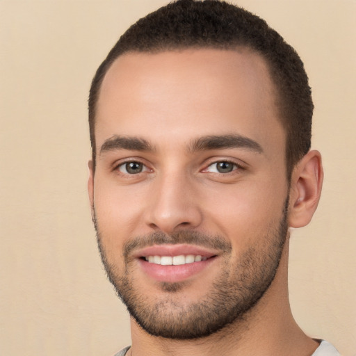 Joyful white young-adult male with short  brown hair and brown eyes