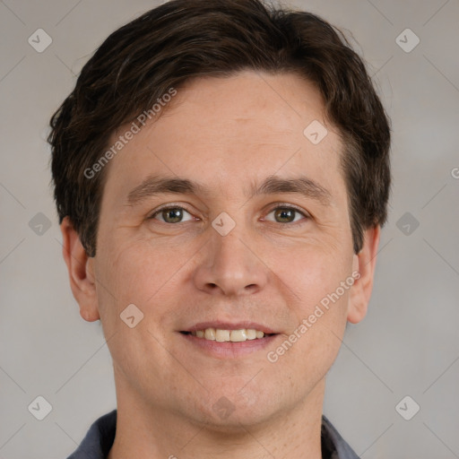 Joyful white adult male with short  brown hair and grey eyes