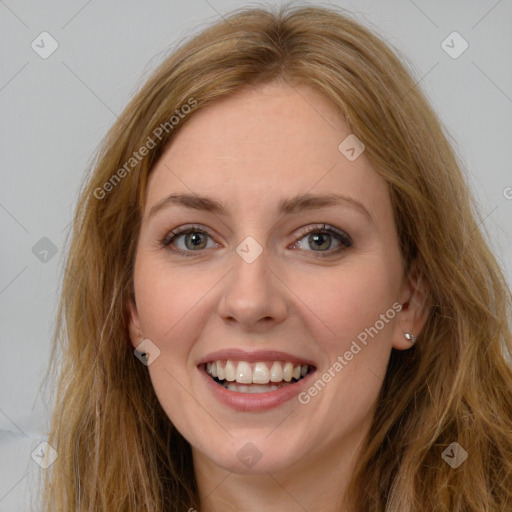 Joyful white young-adult female with long  brown hair and green eyes