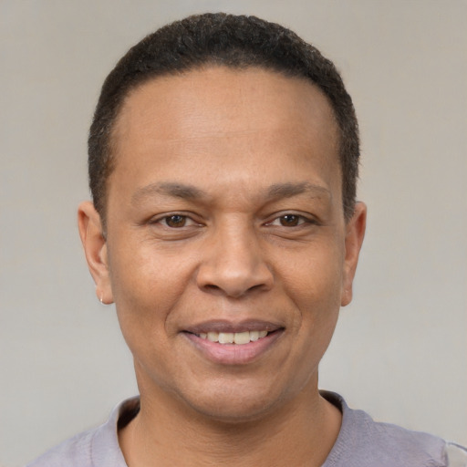 Joyful latino adult male with short  brown hair and brown eyes