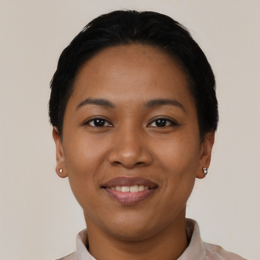 Joyful latino young-adult female with short  black hair and brown eyes