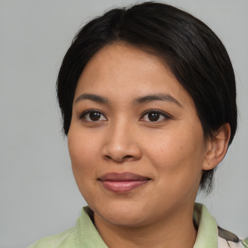 Joyful asian young-adult female with medium  brown hair and brown eyes