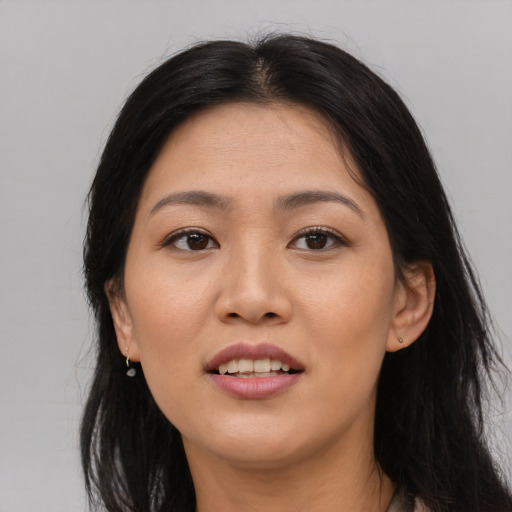 Joyful asian young-adult female with long  brown hair and brown eyes