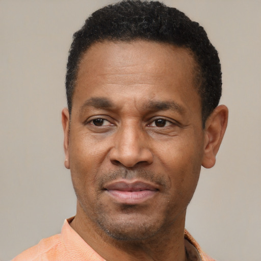 Joyful latino adult male with short  black hair and brown eyes