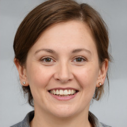 Joyful white adult female with medium  brown hair and brown eyes