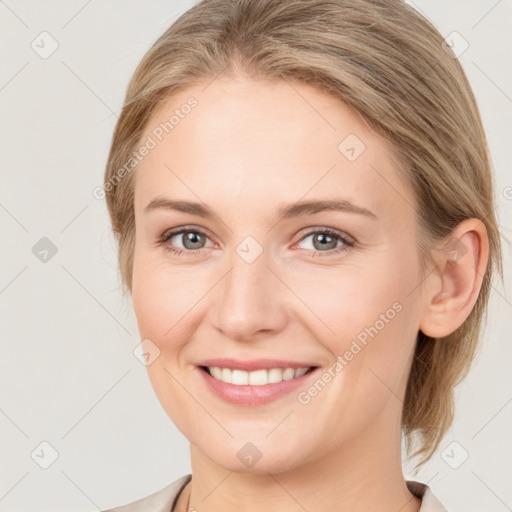 Joyful white young-adult female with medium  brown hair and blue eyes