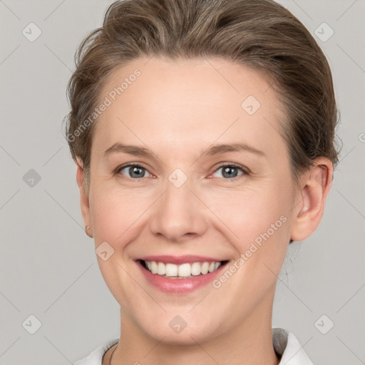 Joyful white young-adult female with short  brown hair and grey eyes