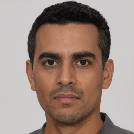 Neutral latino young-adult male with short  black hair and brown eyes