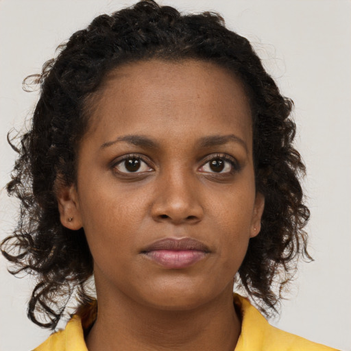 Neutral black young-adult female with medium  brown hair and brown eyes