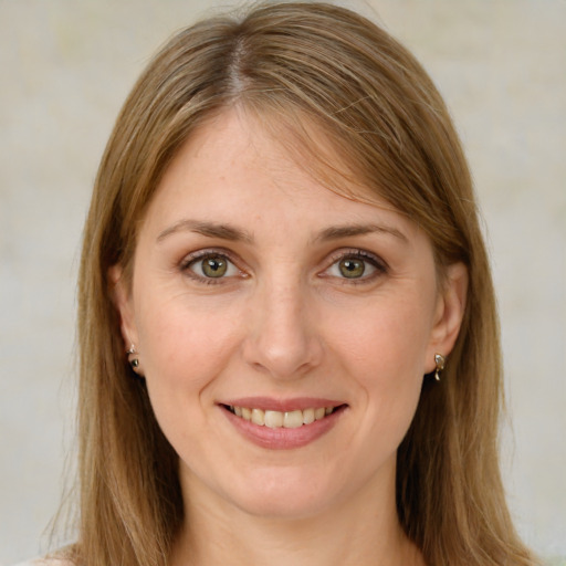 Joyful white young-adult female with long  brown hair and green eyes