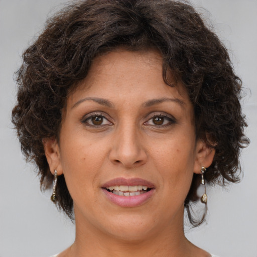 Joyful white adult female with medium  brown hair and brown eyes
