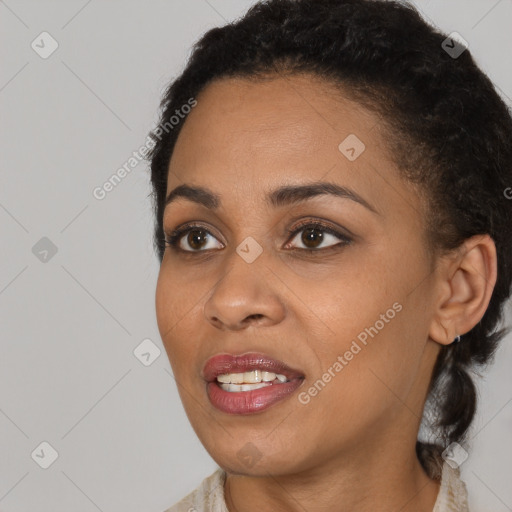 Joyful black young-adult female with short  black hair and brown eyes