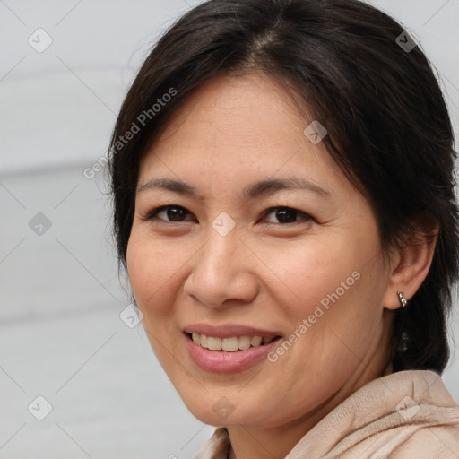 Joyful white adult female with medium  brown hair and brown eyes