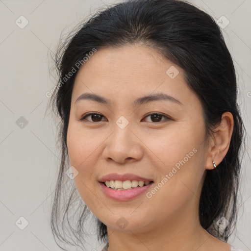 Joyful asian young-adult female with medium  brown hair and brown eyes