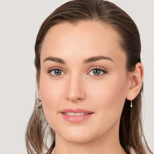 Joyful white young-adult female with long  brown hair and grey eyes