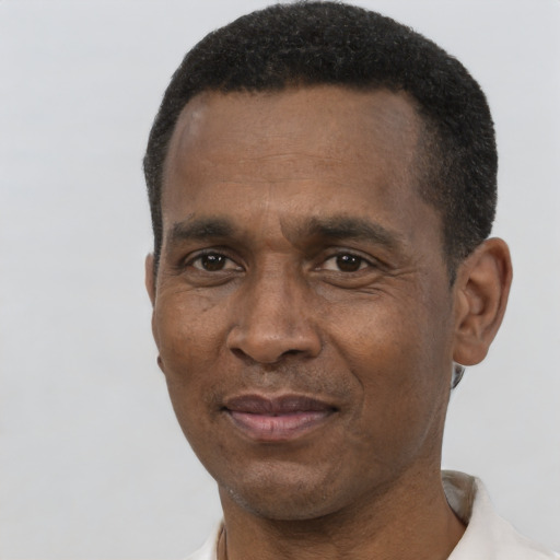 Joyful black adult male with short  black hair and brown eyes