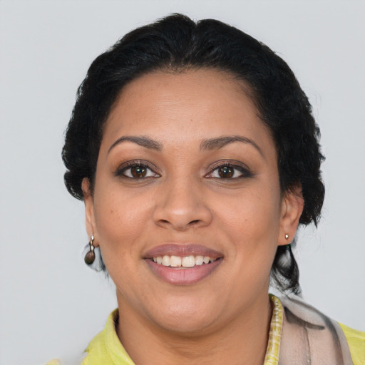 Joyful latino young-adult female with short  brown hair and brown eyes