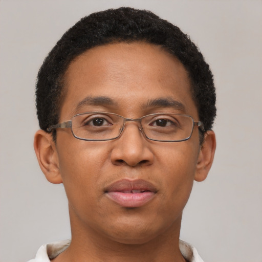 Joyful black adult male with short  brown hair and brown eyes