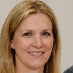 Joyful white adult female with long  brown hair and brown eyes