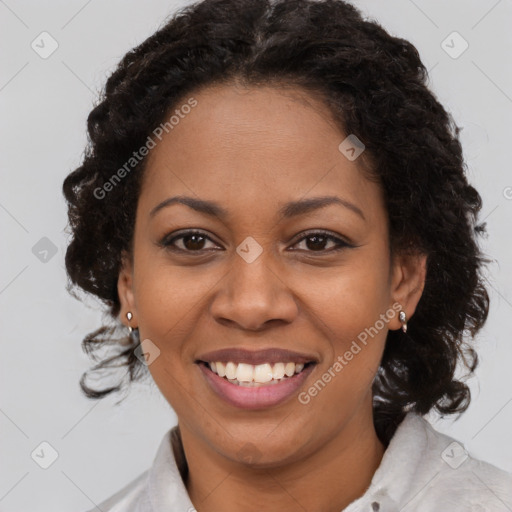 Joyful black adult female with medium  brown hair and brown eyes