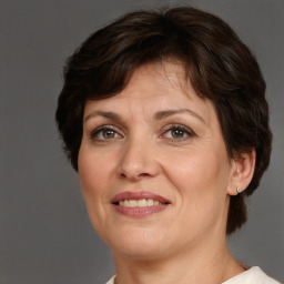 Joyful white adult female with short  brown hair and brown eyes