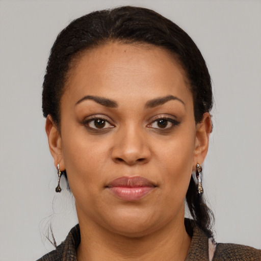 Joyful black young-adult female with medium  brown hair and brown eyes