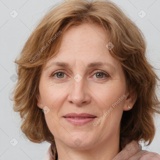 Joyful white adult female with medium  brown hair and blue eyes