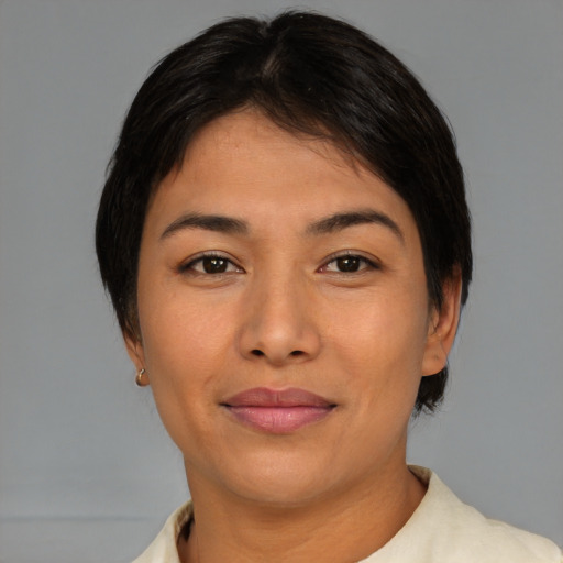 Joyful asian young-adult female with short  brown hair and brown eyes