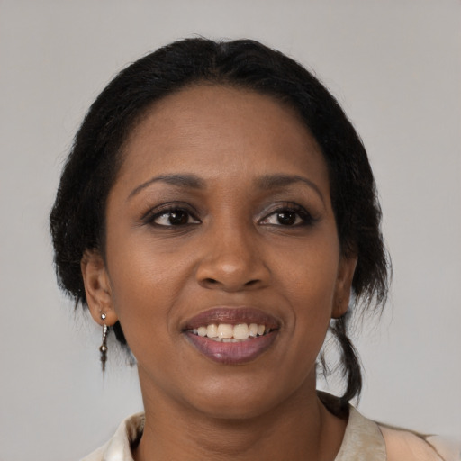 Joyful black young-adult female with medium  brown hair and brown eyes