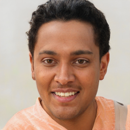 Joyful latino young-adult male with short  brown hair and brown eyes