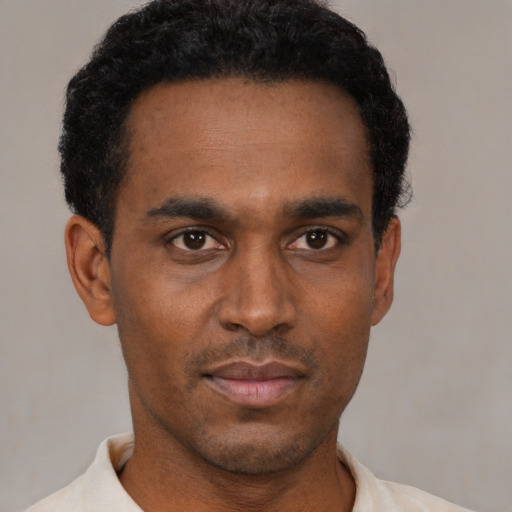 Neutral black young-adult male with short  black hair and brown eyes