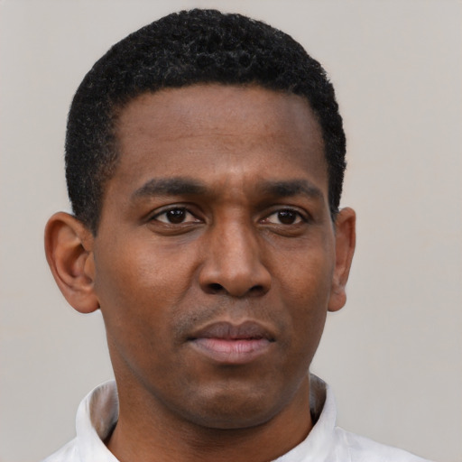 Neutral black young-adult male with short  black hair and brown eyes