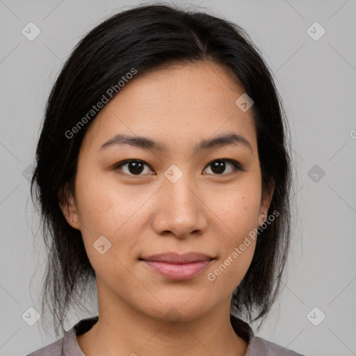 Joyful latino young-adult female with medium  brown hair and brown eyes