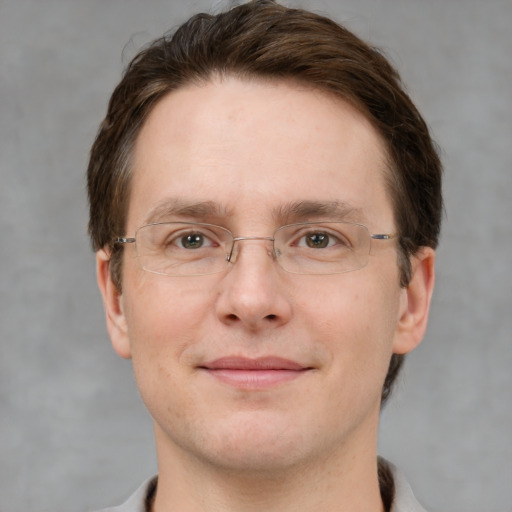 Joyful white adult male with short  brown hair and grey eyes