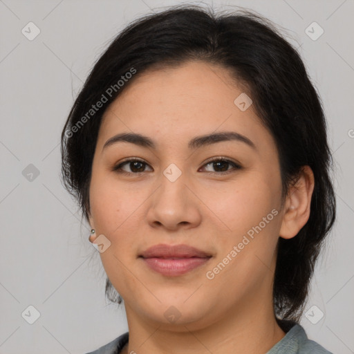 Joyful latino young-adult female with medium  brown hair and brown eyes