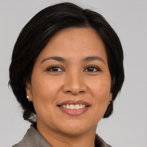 Joyful asian adult female with medium  brown hair and brown eyes