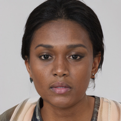 Neutral black young-adult female with medium  brown hair and brown eyes