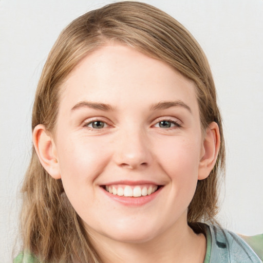 Joyful white young-adult female with medium  brown hair and blue eyes