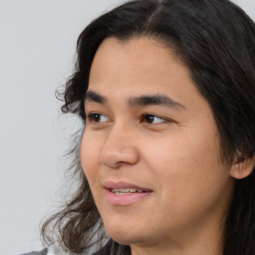 Joyful latino young-adult male with medium  brown hair and brown eyes