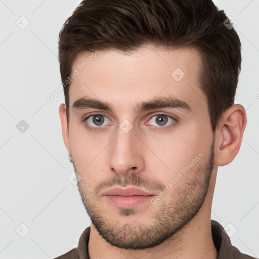 Neutral white young-adult male with short  brown hair and brown eyes