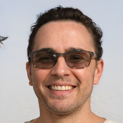 Joyful white adult male with short  brown hair and brown eyes