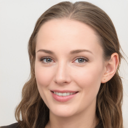 Joyful white young-adult female with long  brown hair and grey eyes