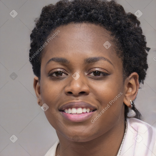 Joyful black young-adult female with short  black hair and brown eyes